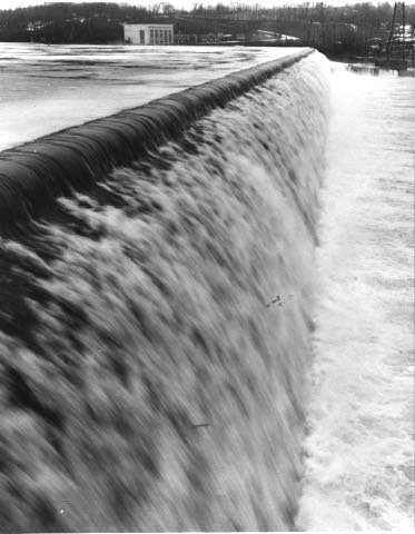 Water flowing over a dam; looking across the dam